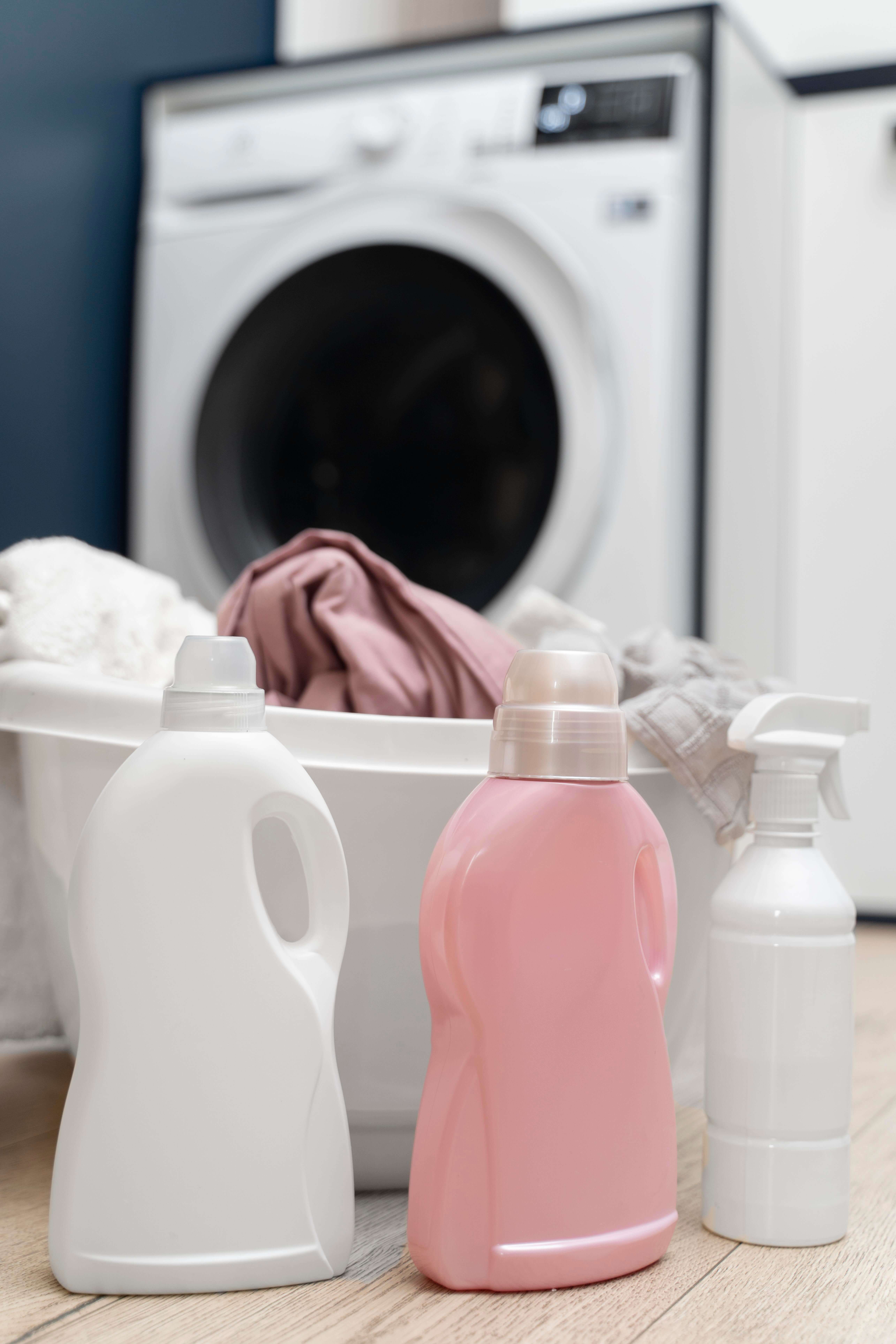 A bottle of gentle detergent alongside a set of colorful kids pajamas