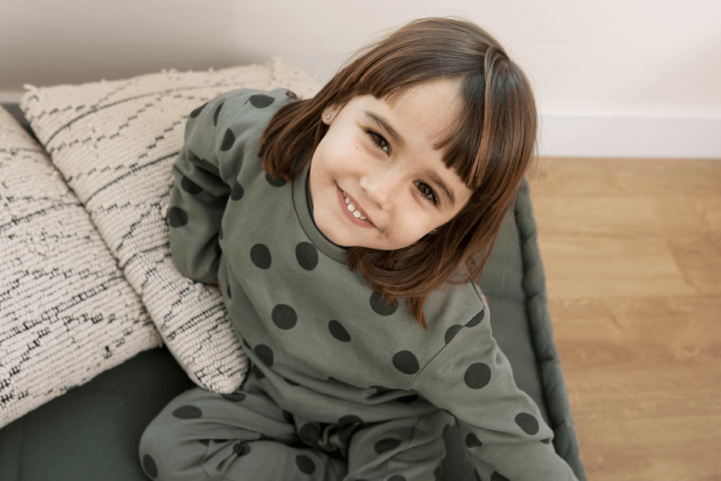 A toddler giggling in a snug, safe set of PJs