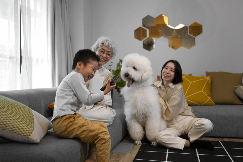 Warm living room setting, family snuggled together, pets included, in their matching PJs