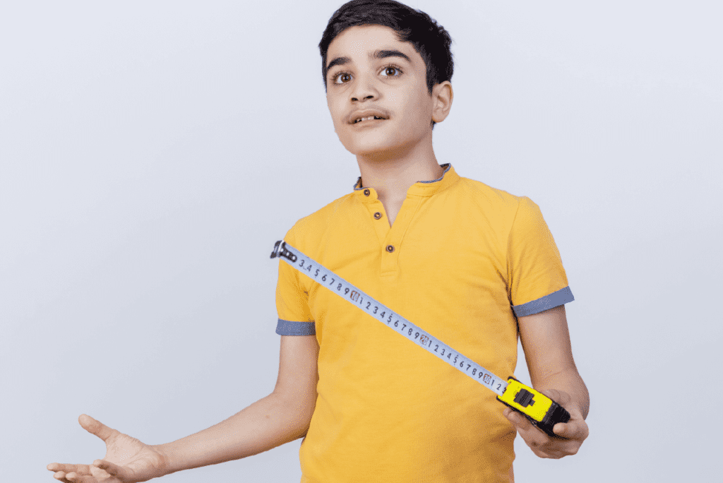 A child being measured around the chest area