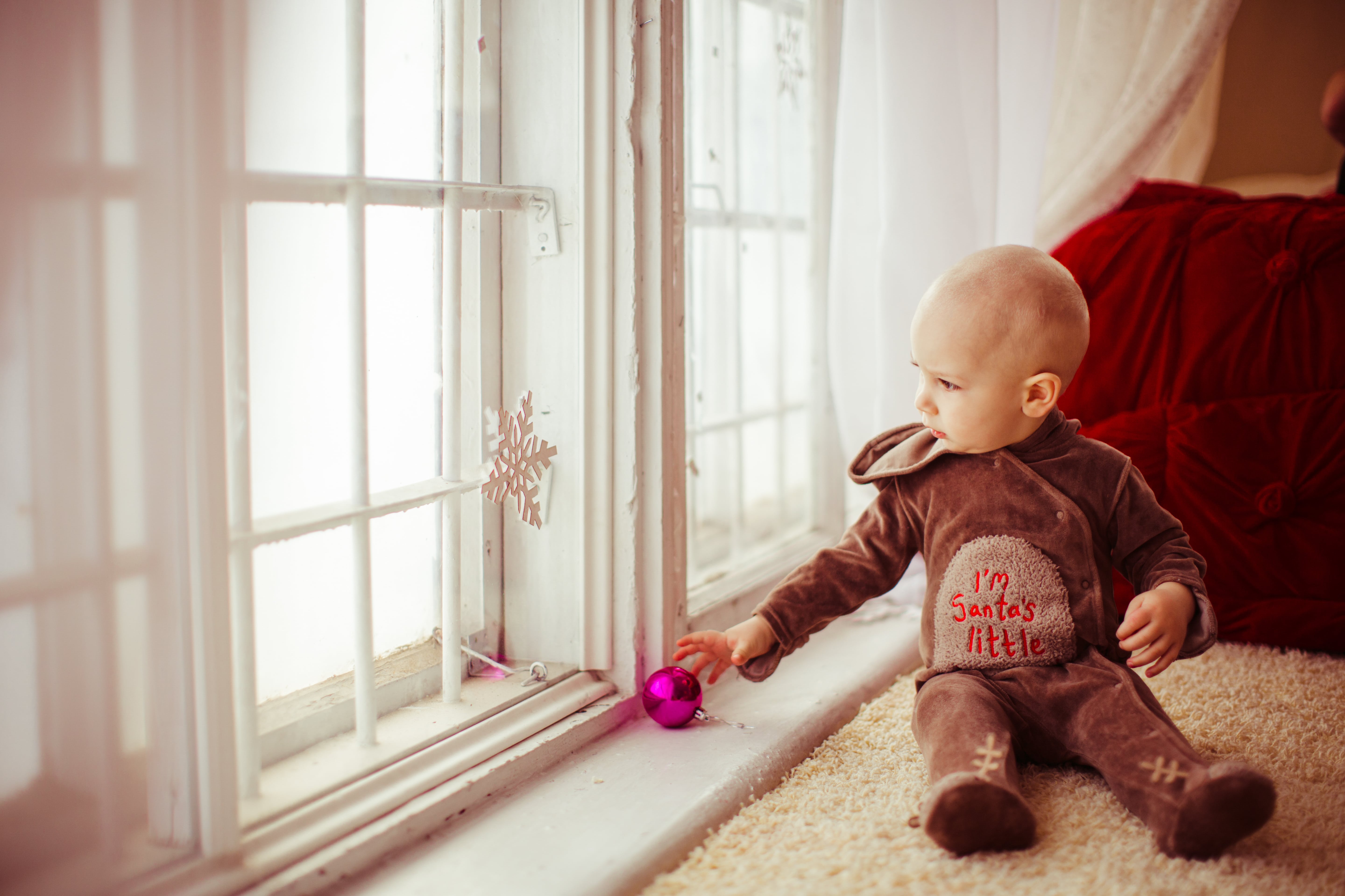 A child by the window, the golden sun highlighting their cute PJs