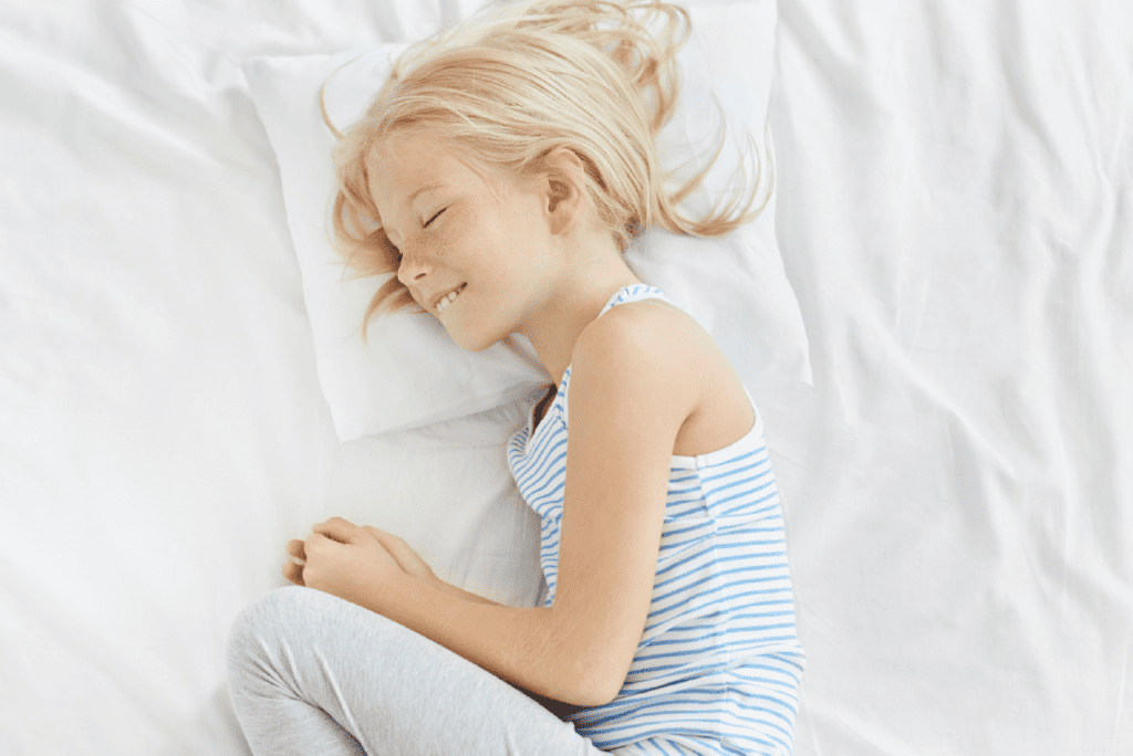 A child, enveloped in the softness of their pajama, deeply asleep