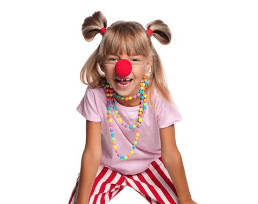 A child in multicolored striped pajamas smiling brightly