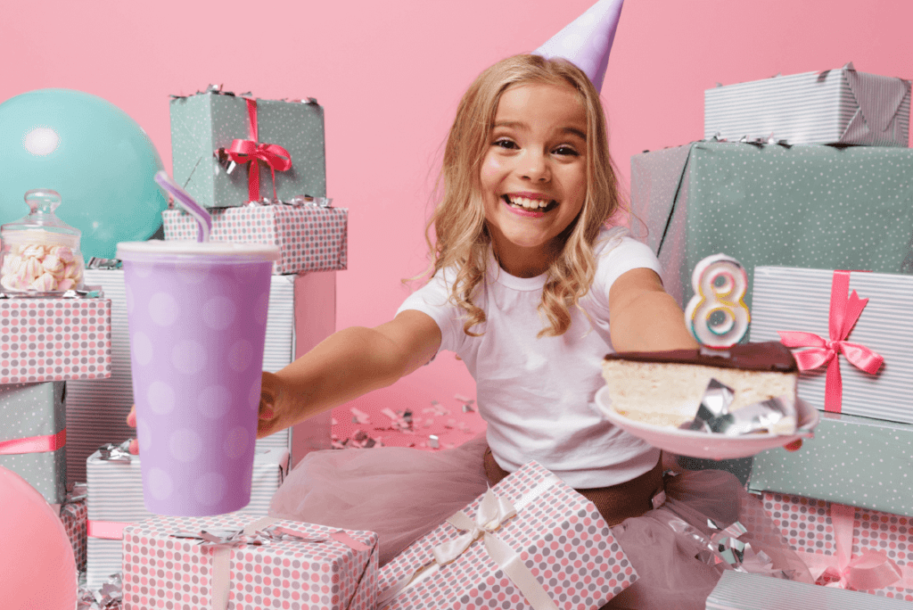 A child in new pajamas excitedly opening birthday presents