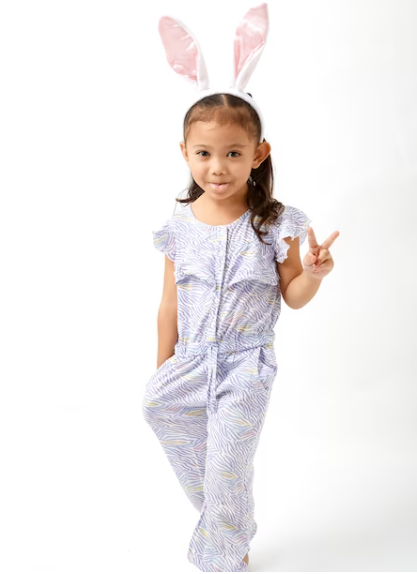 A child wearing pajamas featuring designs from popular fairytales.png