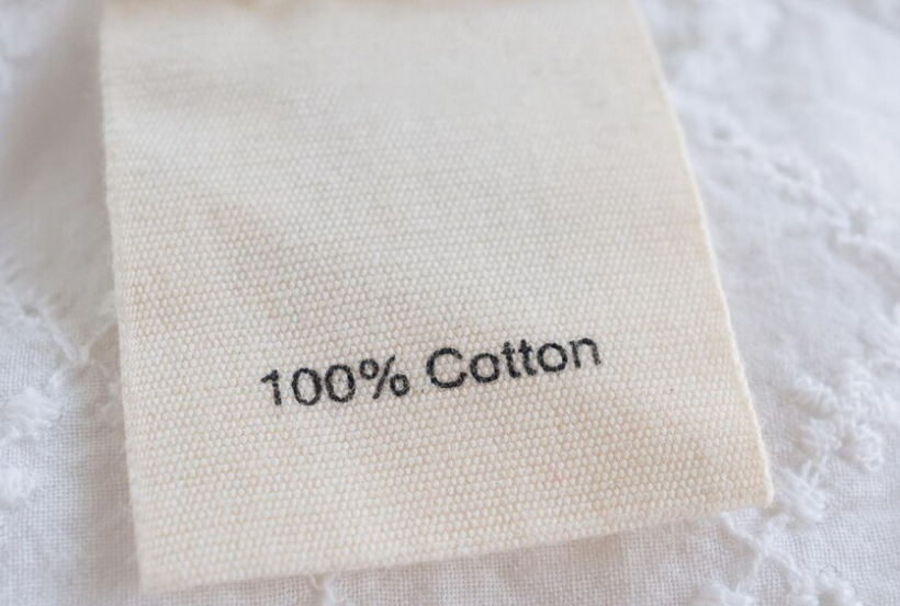 A-close-up-of-a-tag-showcasing-100-Organic-Cotton