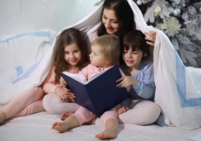 A family cuddled together in matching fairytale pajamas, reading a story