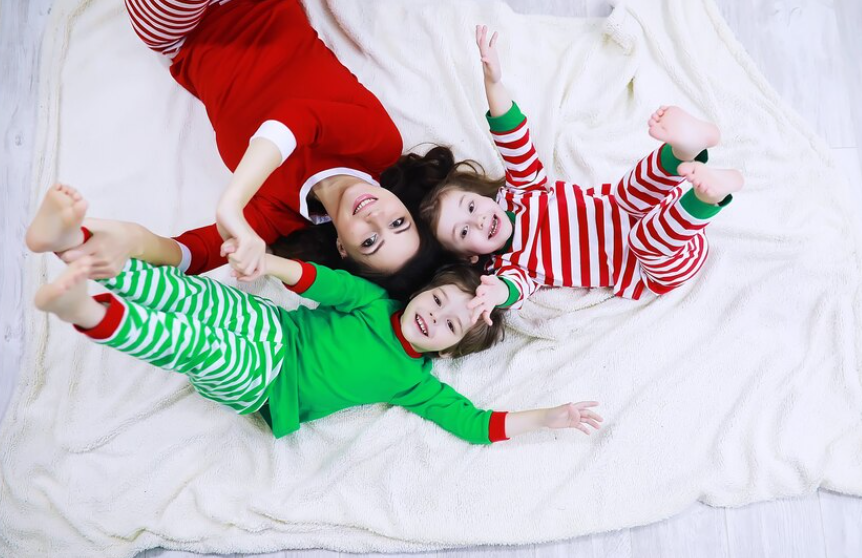 A group of kids in various trendy pajamas, laughing together