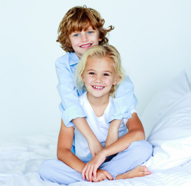 A kid in soft blue linen pajamas