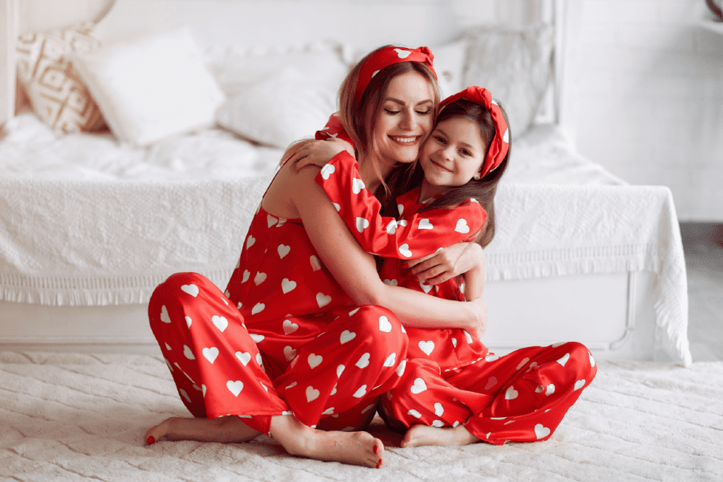 A mother and child posing in matching pajamas