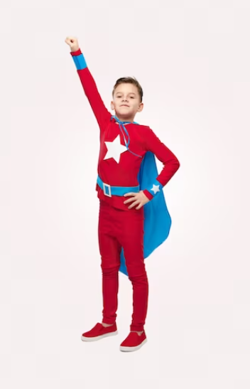 A child proudly showing off pajamas with superhero logos