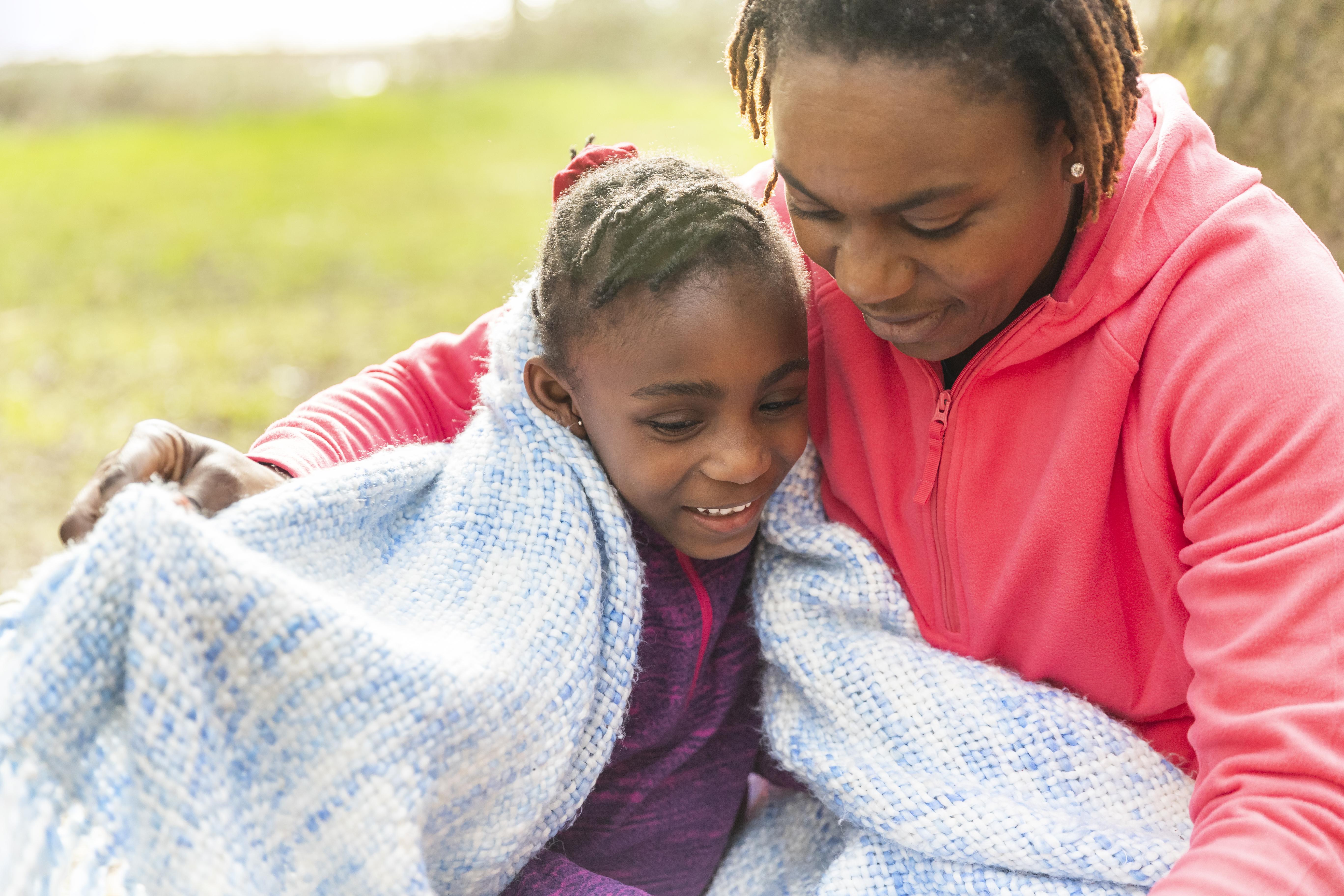 An African child wrapped in a traditional textile, ready for bedtime