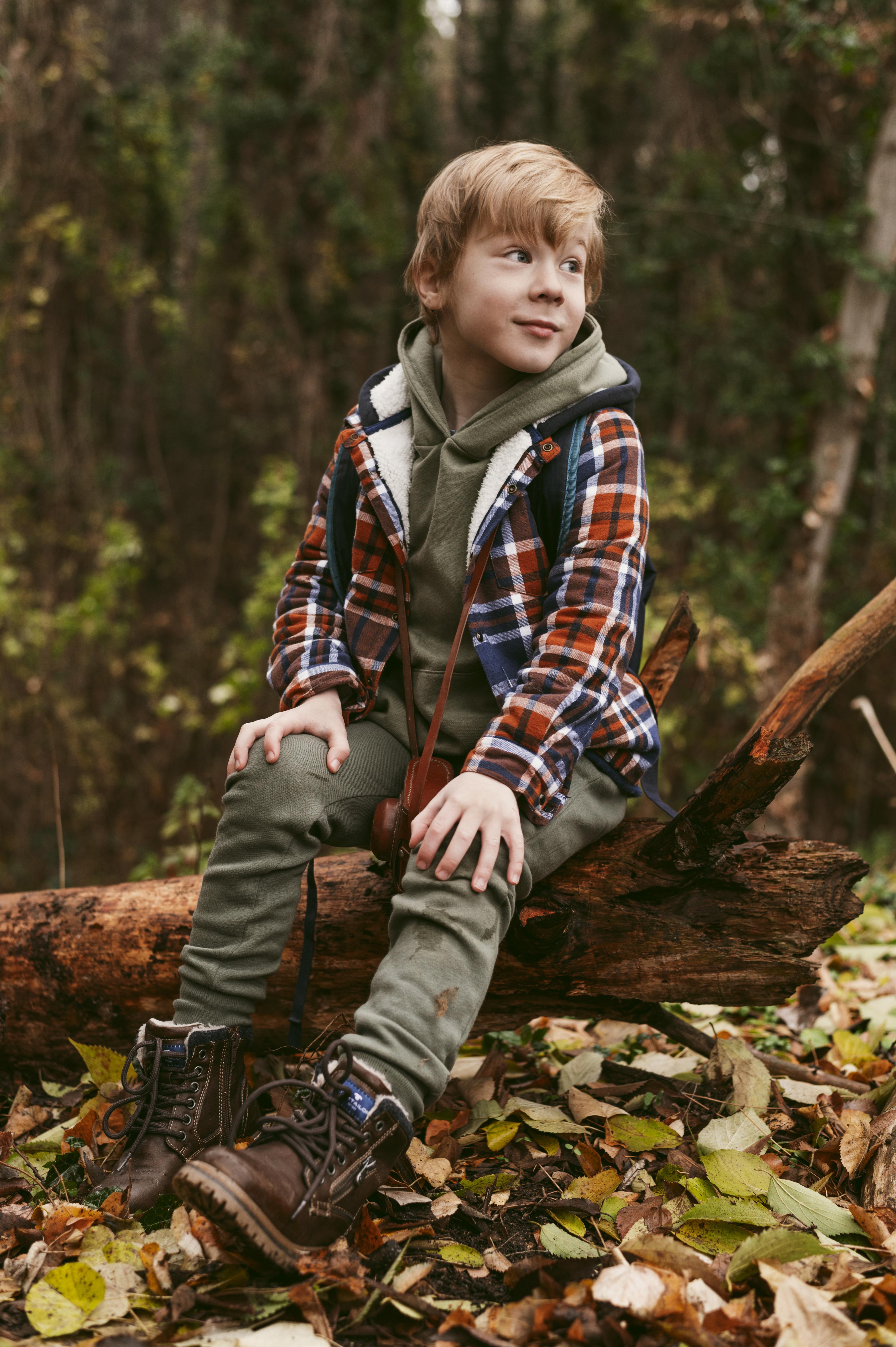 Celebrity child in pajamas adorned with tiny trees and mountains