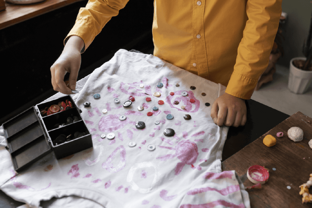 Child drawing on pajamas with colorful fabric markers