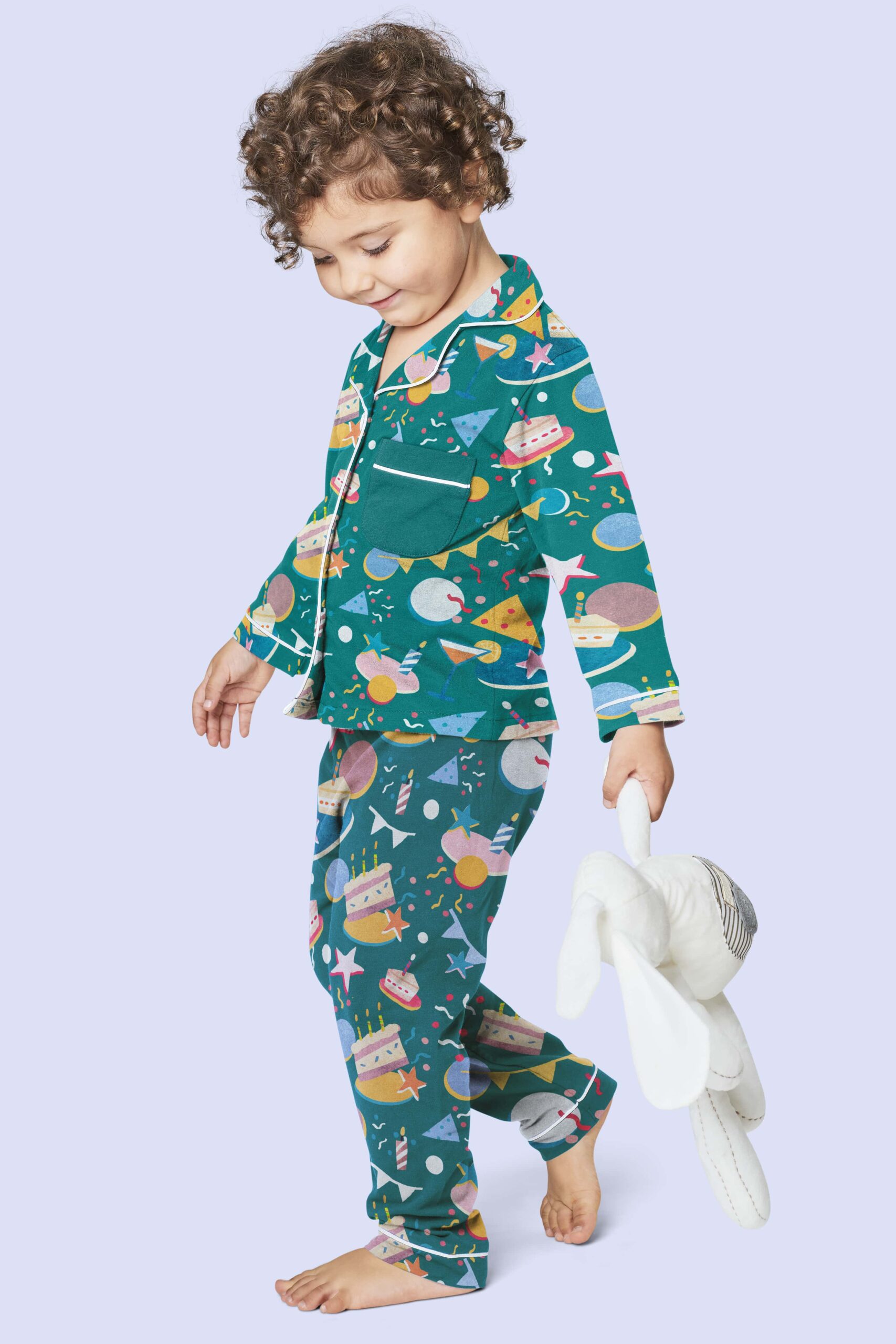 Child in a pastel-colored PJ, with a minimal pattern