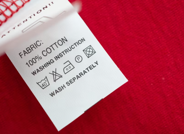 Close-up of a fabric tag showing 100% cotton