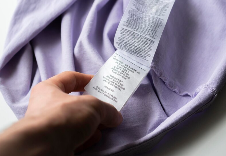 Close up of a pajama label with a sizing chart and fabric details.png