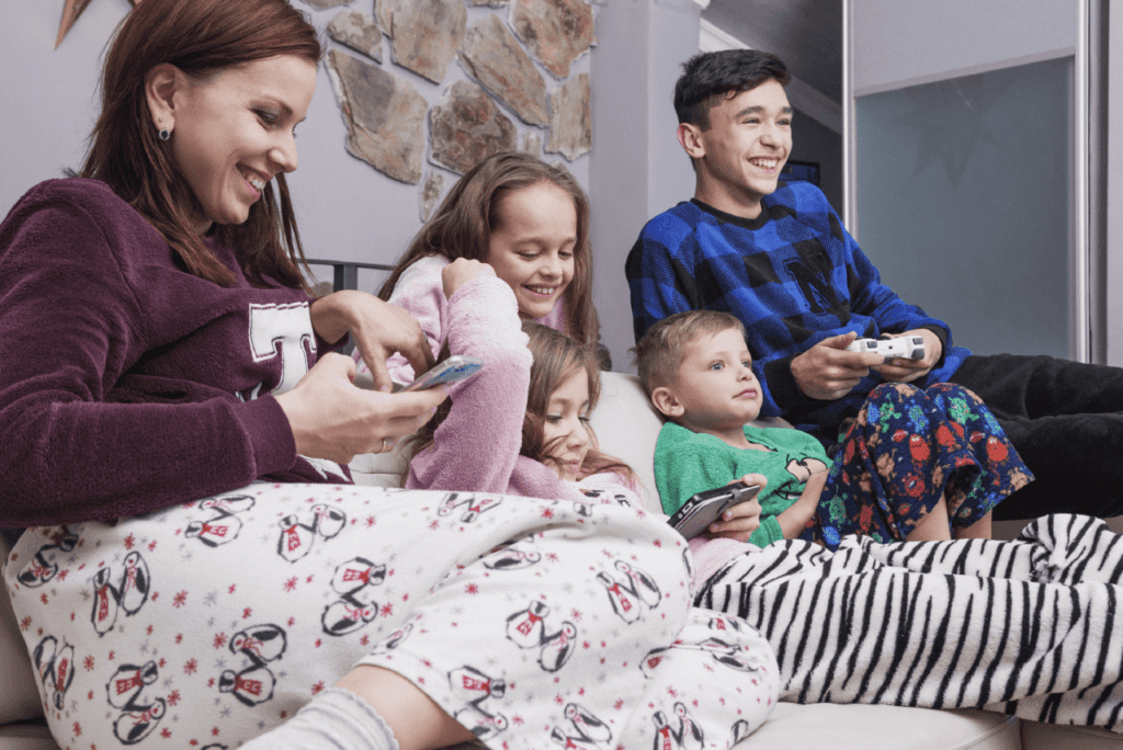 Families and kids laughing during a pajama parade