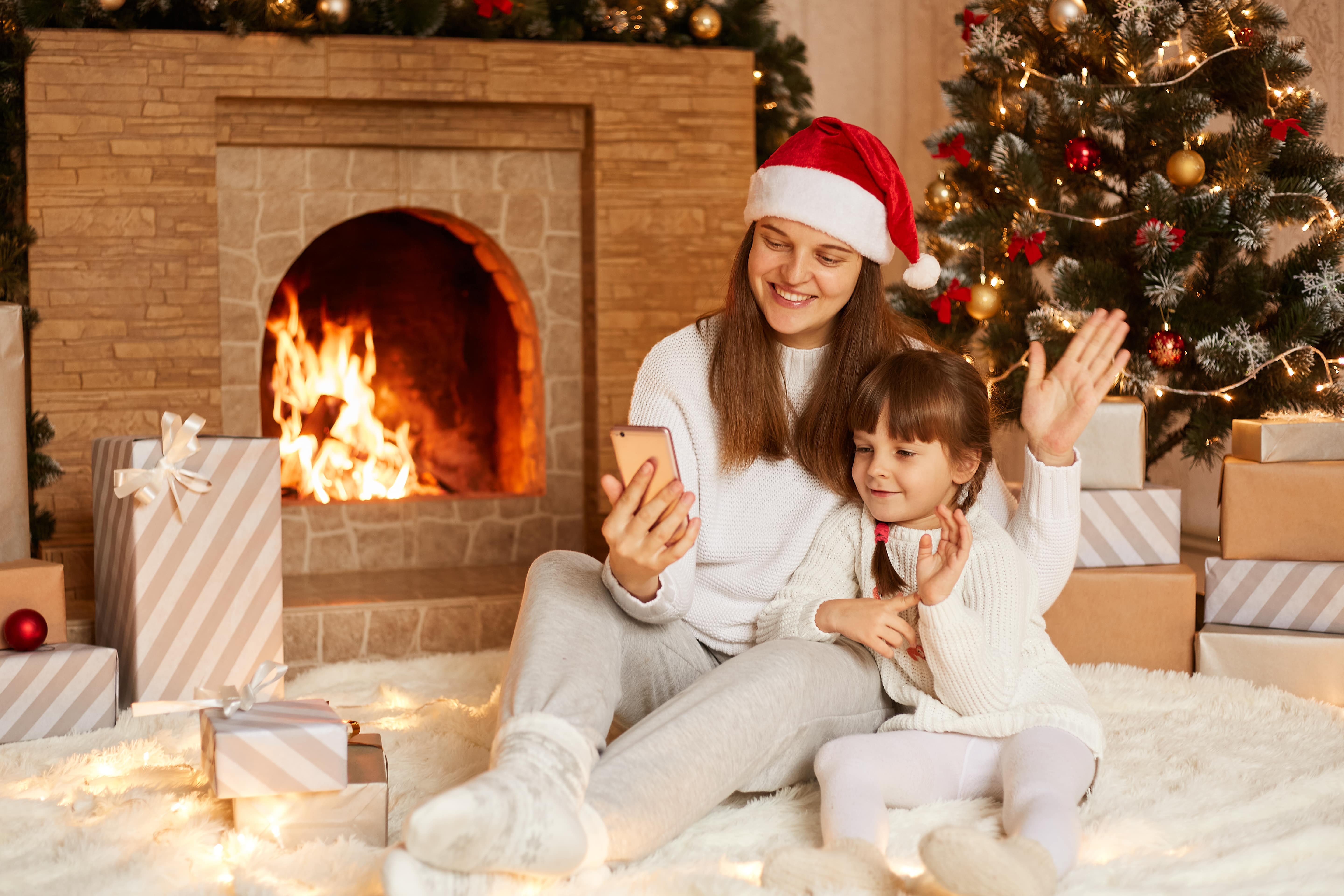 Family posing in front of a fireplace in their holiday pajamas