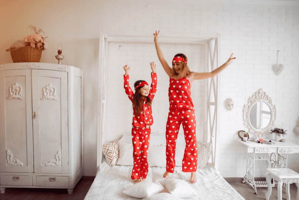 Mom and child holding hands showcasing their similar pajamas