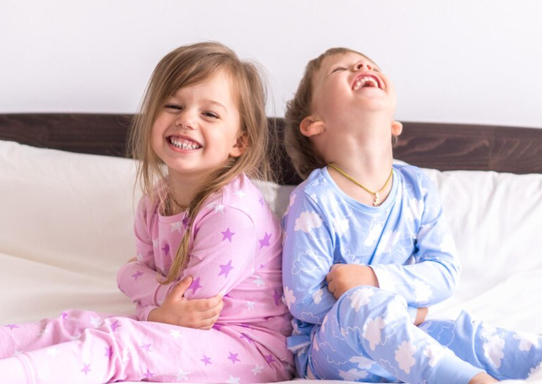 Two kids in matching pajamas, recalling a fun sleepover