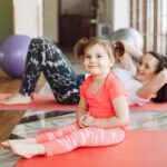 Mother and daughter training in a gym